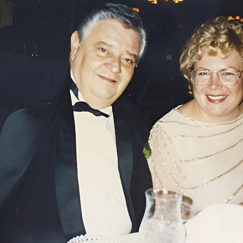 Smiling couple dressed for formal event.
