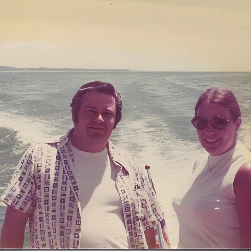 Couple on a boat with ocean background.