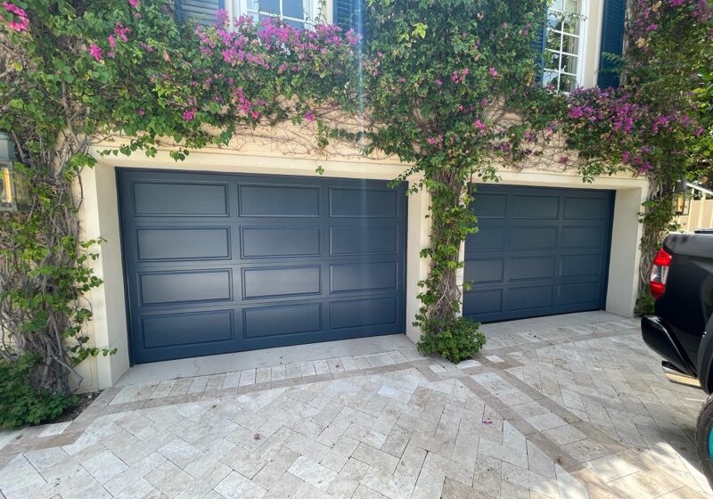 Ivy-covered house with blue garages