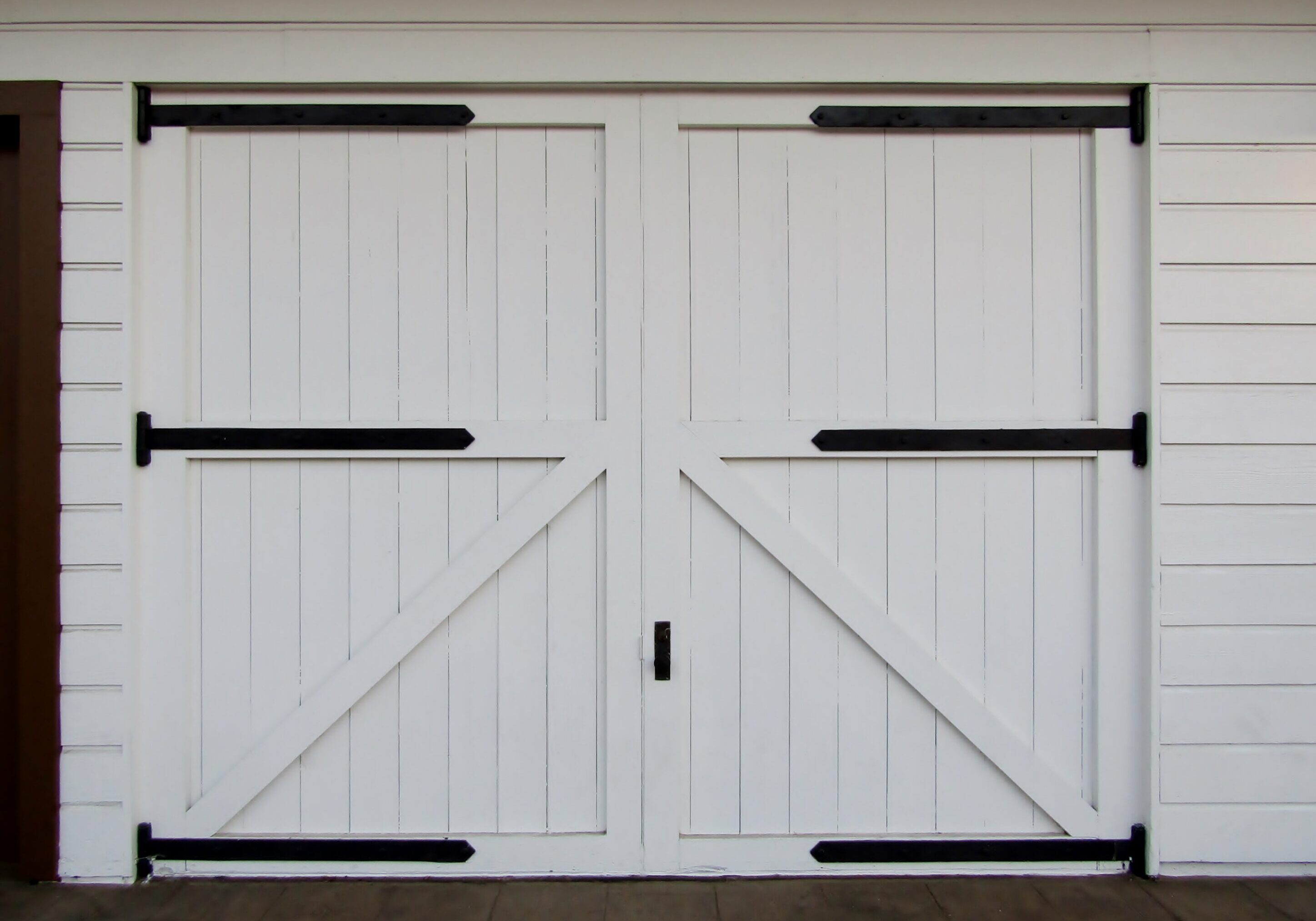 Wooden barn doors with rustic hardware.